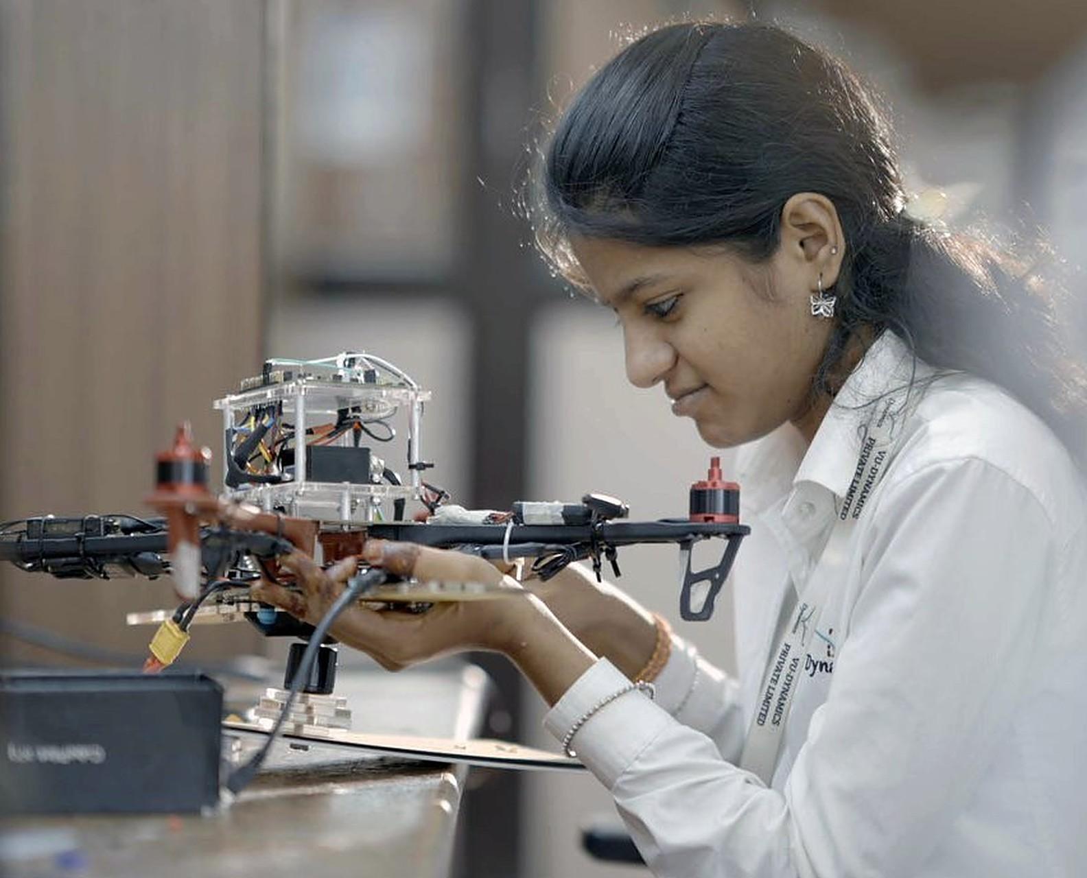 A student assembling a drone