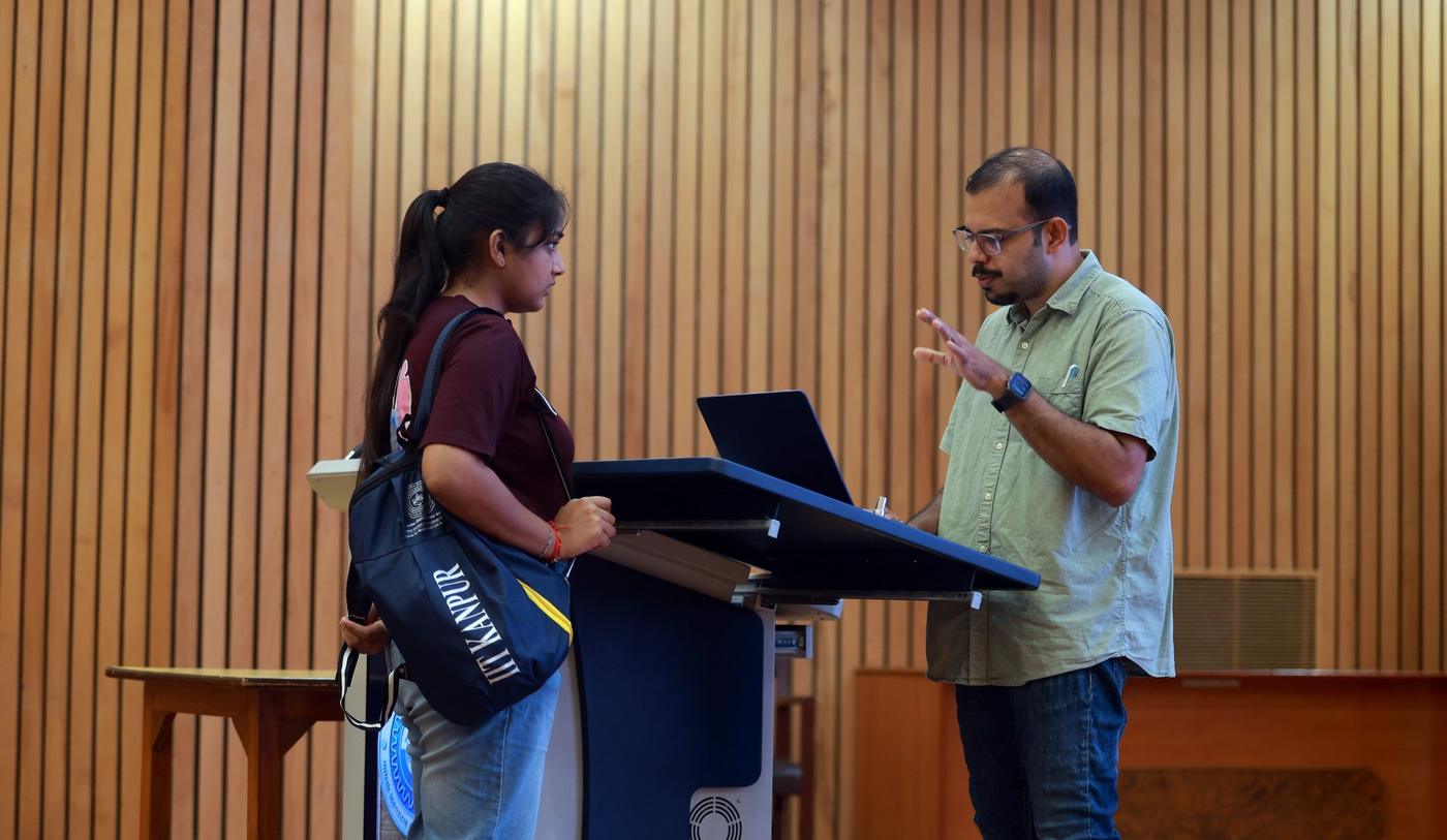 A faculty member in discussion with a student