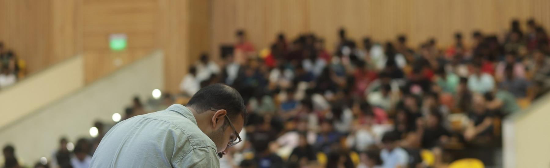 A faculty member in discussion with a student