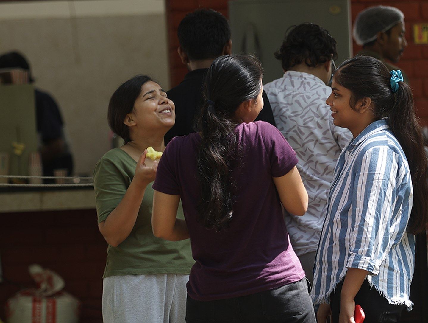 Students sharing a laugh outside a hall of residence