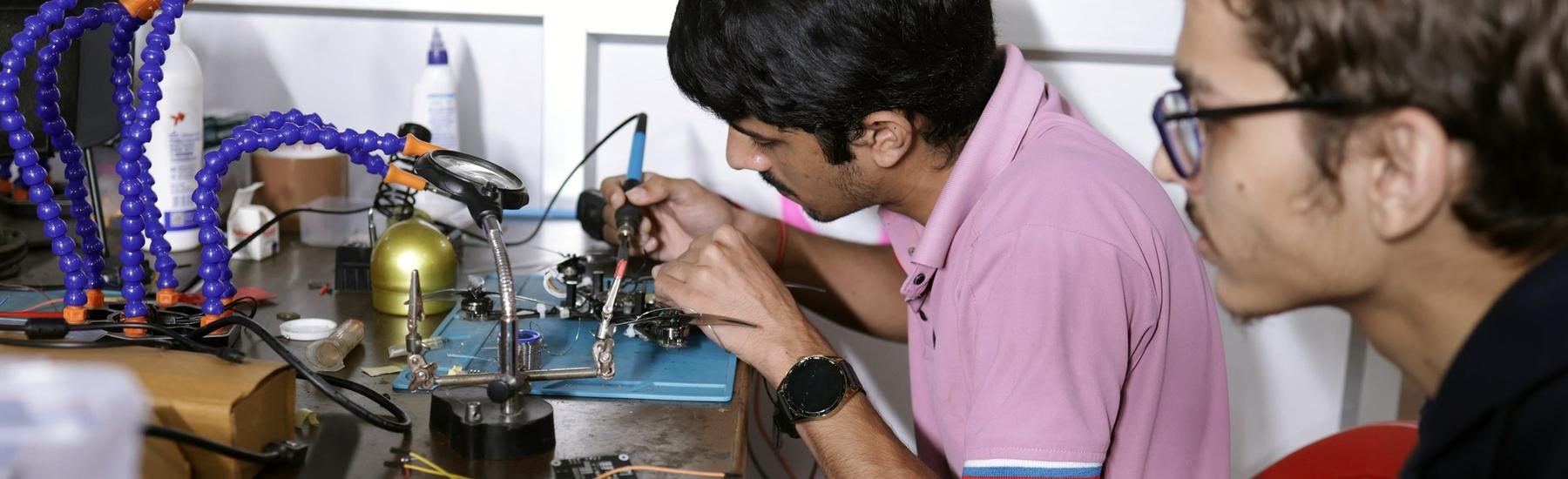 Students soldering electronics in a lab