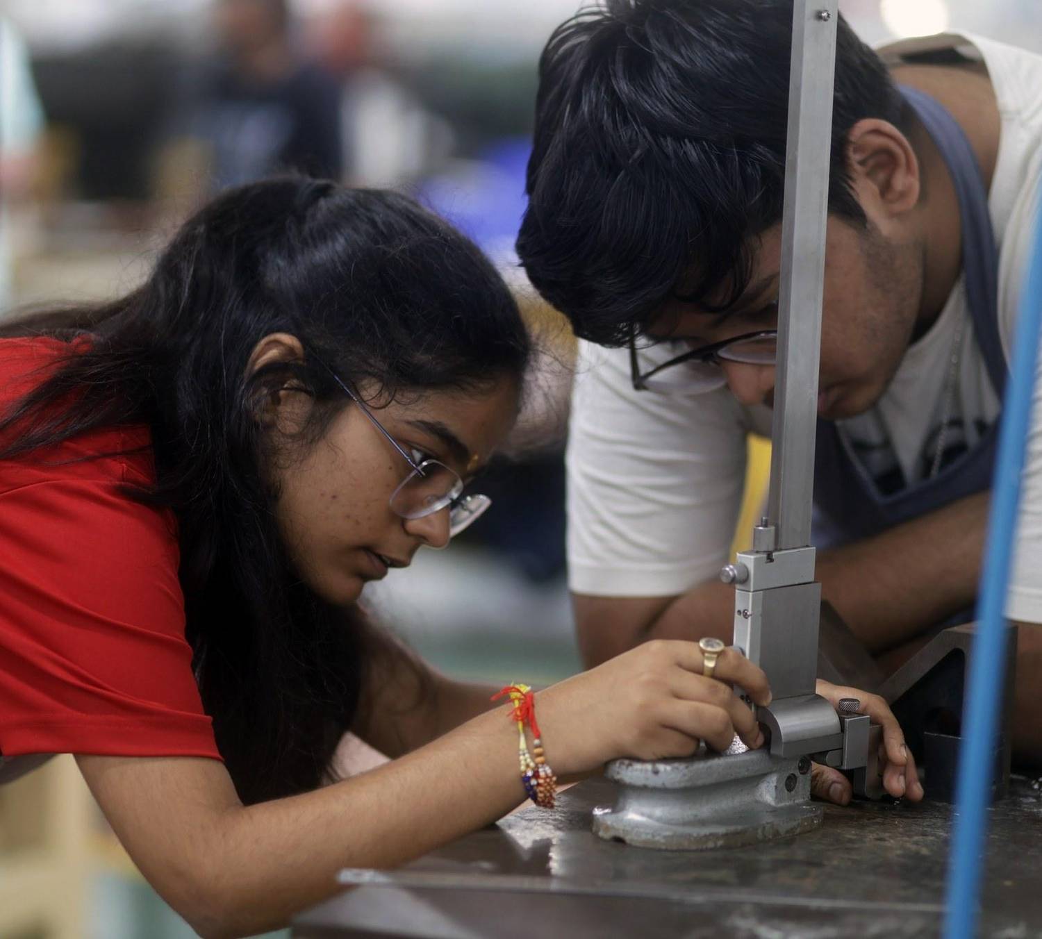 Students measuring a part with a height gauge