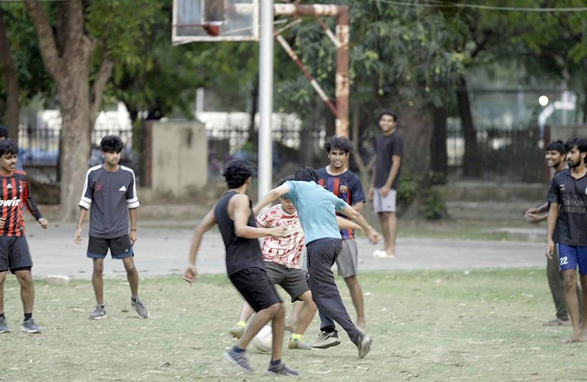 Students playing football on the campus grounds