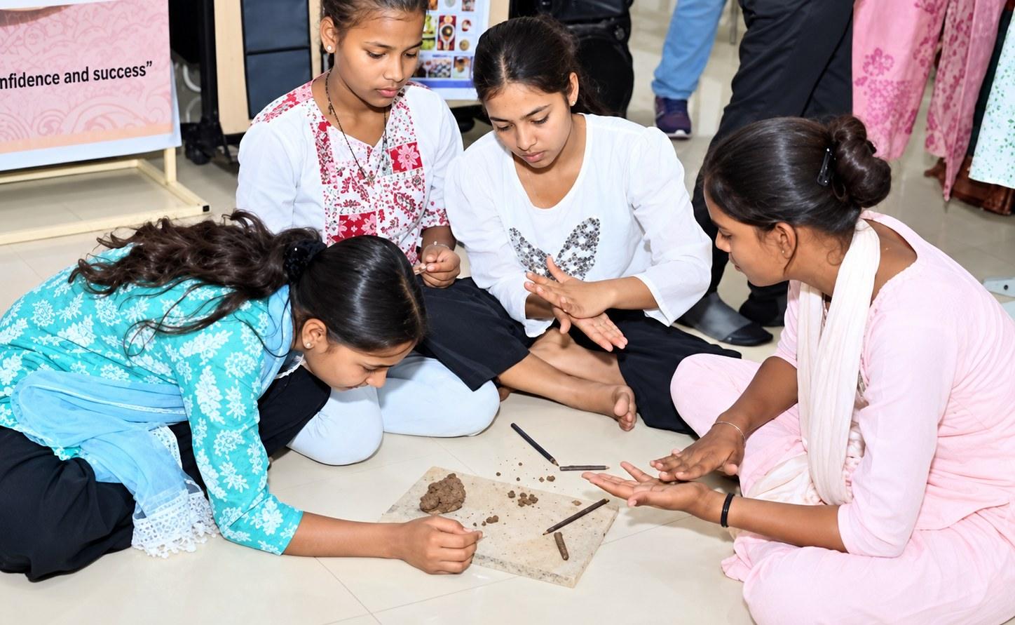 Rural students seated on the floor of a classroom learning with a volunteer