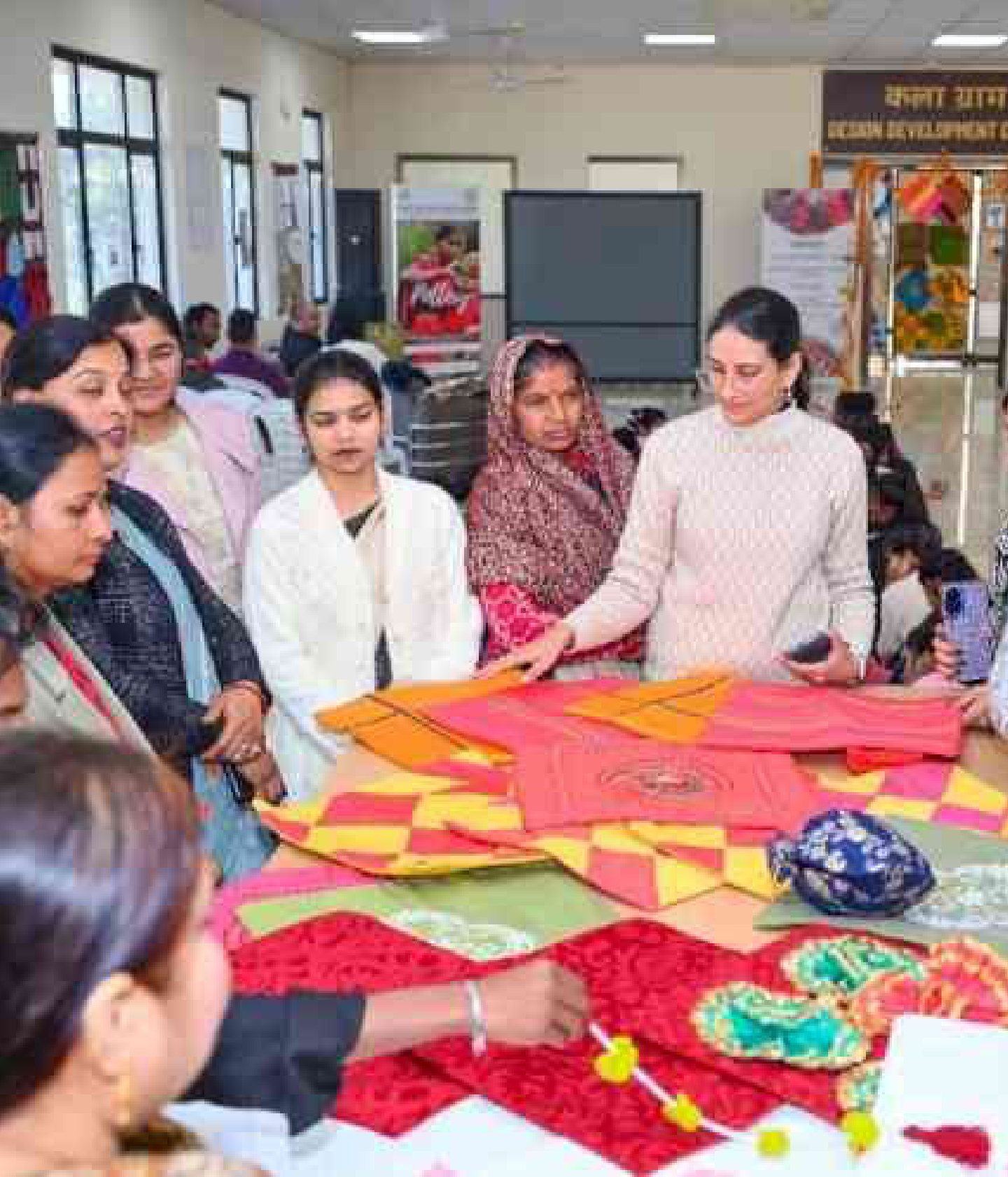 Artisans and students examining textiles at Kalagram, the Design Development Centre