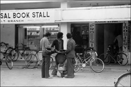A group of men standing outside a store

AI-generated content may be incorrect.