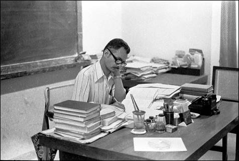 A person sitting at a desk with books

AI-generated content may be incorrect.